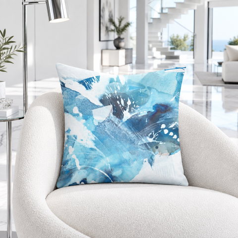 Aquatic Blue Waters pillow on a curved white lounge chair in a modern residence