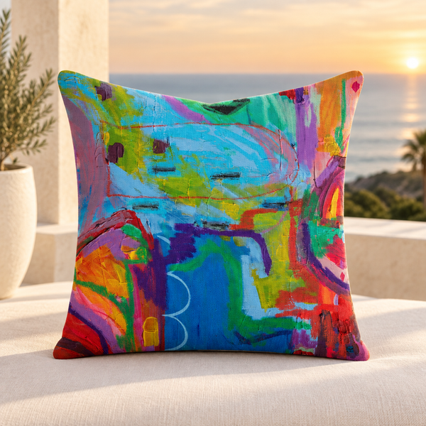 Close-up lifestyle photo of the Destination Happiness 22x22 pillow with its front artwork in a Malibu loggia at sunset