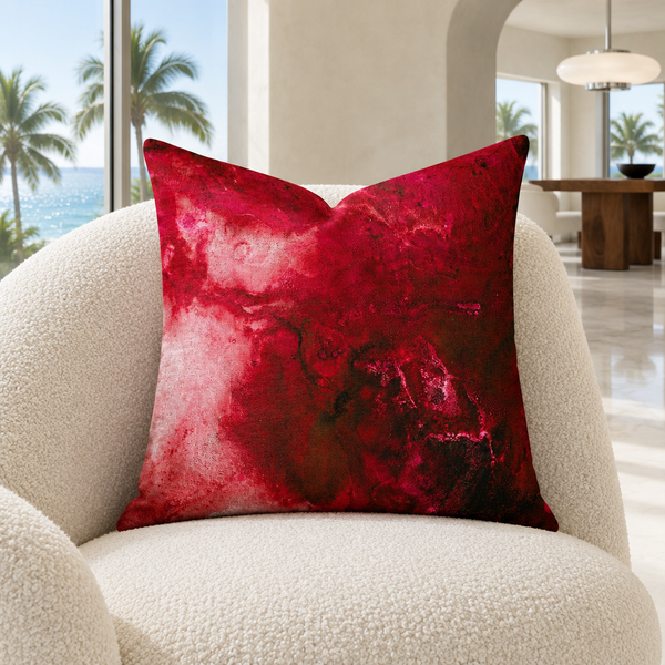 Crimson pillow on an ivory chair in a Miami living room