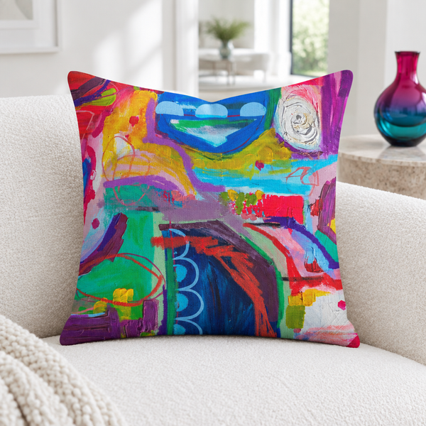 Destination Happiness pillow close-up in a white living room with one modern glass vase
