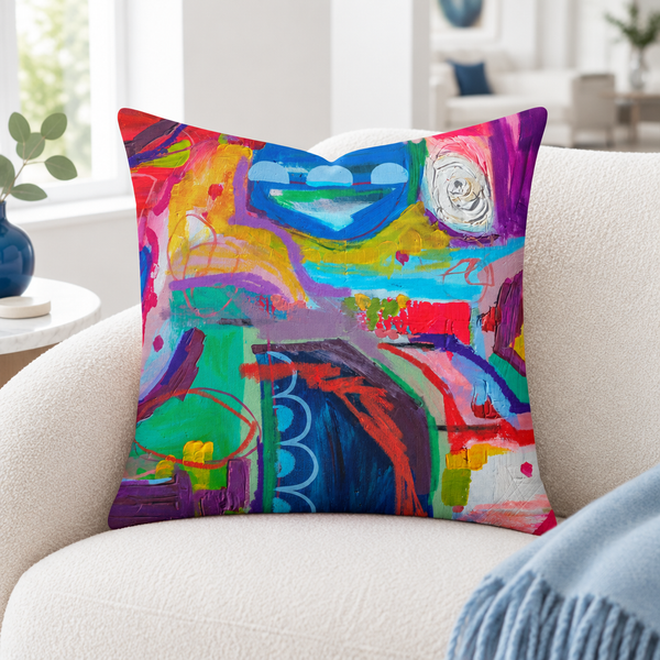 Destination Happiness pillow close-up in a white reading nook with one soft throw