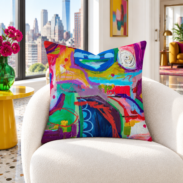 Destination Happiness pillow in a white city loft with saffron and emerald accents