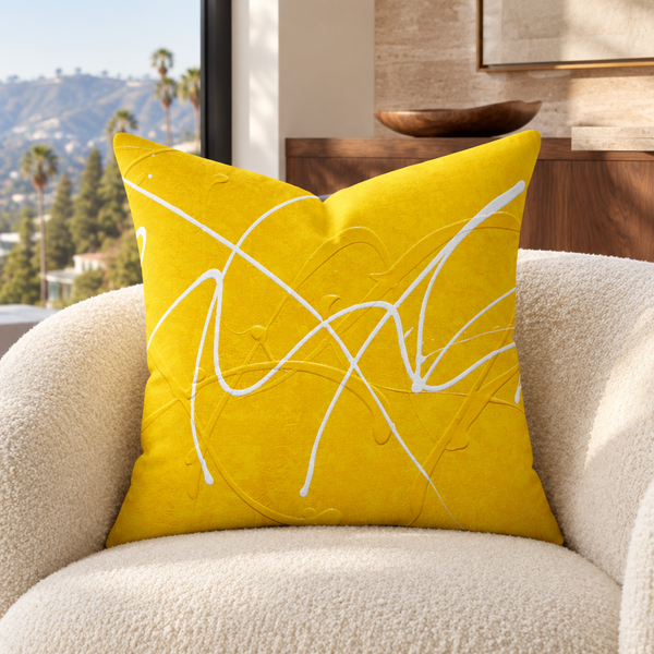 Bright Sunshine art pillow on an ivory chair in a Hollywood Hills home