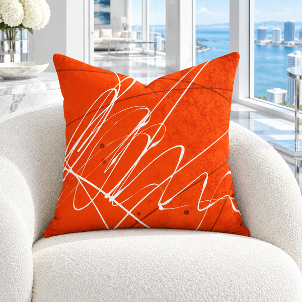 Vermillion art pillow in a cool bright white coastal penthouse