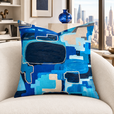 In the City 22-inch pillow close-up in neutral-lit private white gallery with cobalt glass