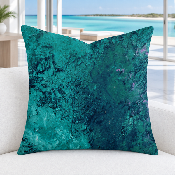 Teal pillow in a cool-white marble-floor Turks and Caicos resort room