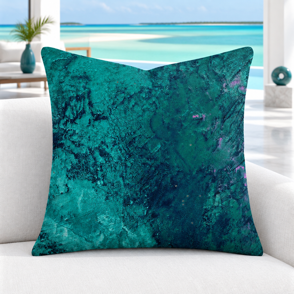 Teal pillow with subtle art-matched accents in a white Turks and Caicos resort