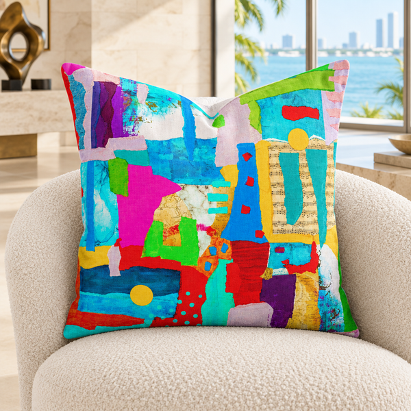 Symphony of Colors - 3 art pillow on an ivory chair in a Miami gallery home