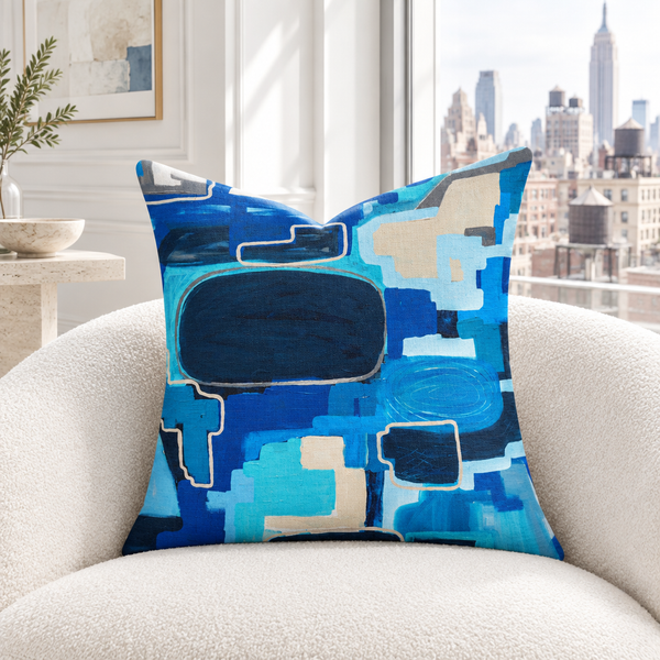In the City 22-inch pillow in white apartment with matching blue details