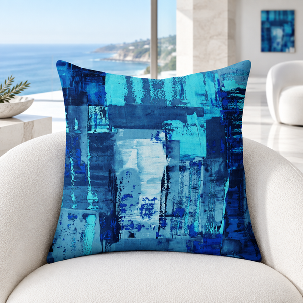 Blue 7 pillow upright in a bright cool-white Malibu cliffside suite with distant matching art