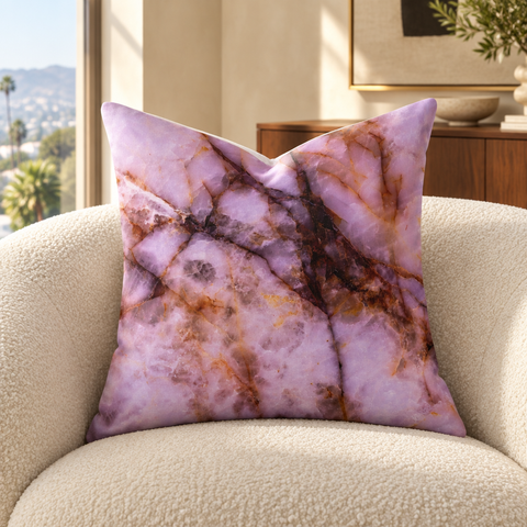 Rose Quartz fine art pillow on an ivory chair in a sunlit luxury room