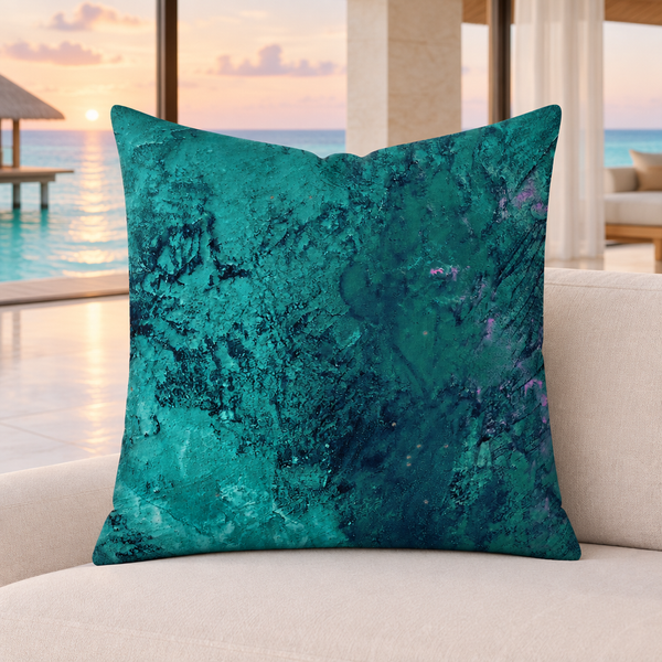 Teal pillow in a modern Maldives suite with subtle sunset light