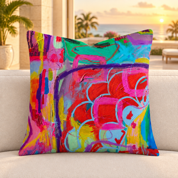 Close-up of the Destination-Happiness -1 square pillow in a Palm Beach-inspired lounge at sunset