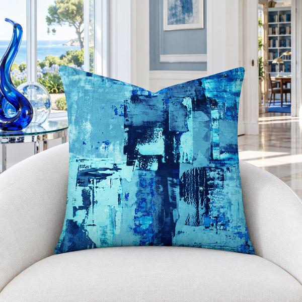 Blue 1 22-inch pillow in cool-white gallery with blue glass and garden view