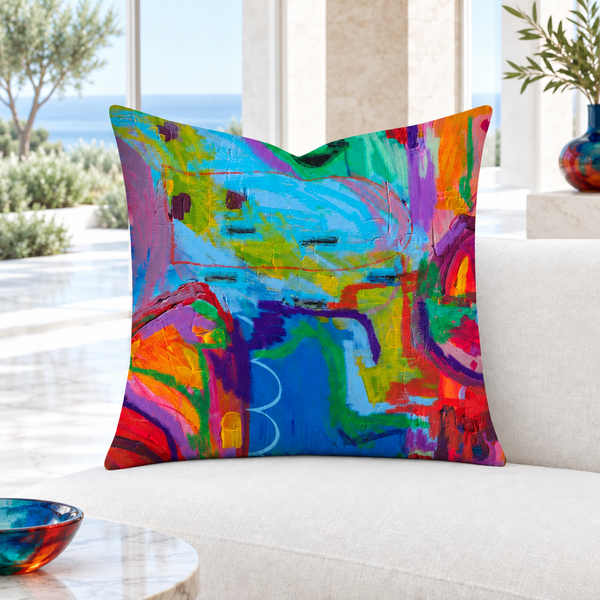 Closer view of the multicolor Destination Happiness pillow in a modern white coastal villa with marble floor