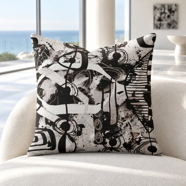Modern Black White and Taupe 2bc pillow upright in a bright cool-white coastal resort suite with marble floors