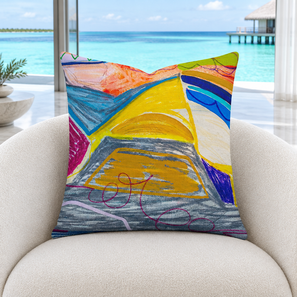 The A New Beginning 22-inch art pillow upright in a cool-white modern Maldives resort lounge with marble floors and a pale aqua lagoon