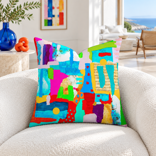 Symphony of Colors pillow in a white coastal room with blue and coral accents