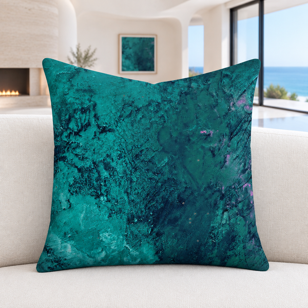 Teal pillow on an ivory sofa in a modern Malibu room with softly blurred matching artwork